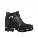 Woman's ankle boot in black leather with buckle and zipper heel 3